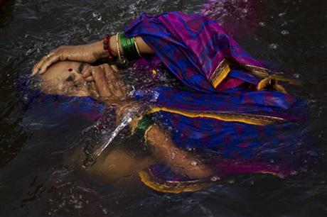 A Hindu devotee performs a holy dip in the Godavari River during Kumbh Mela, or Pitcher Festival, in Nasik, India. AP
