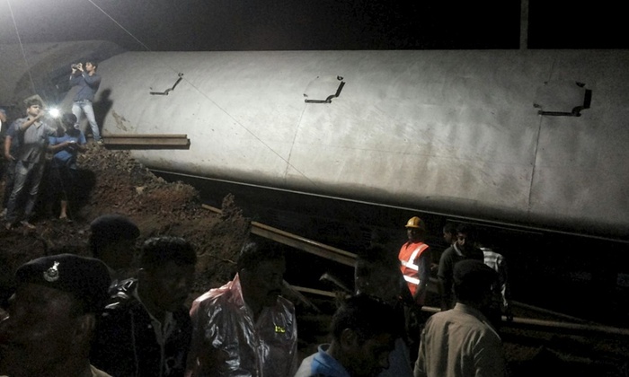 Police, rescuers and onlookers at the site of the twin train derailment near Harda, Madhya Pradesh. Photograph: Reuters 
