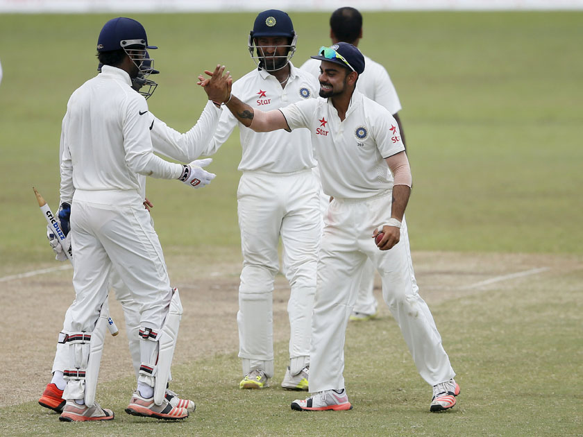 India's captain Virat Kohli (R) celebrates with his teammates after winning their second test cricket match against Sri Lanka in Colombo August 24, 2015. REUTERS/Dinuka Liyanawatte