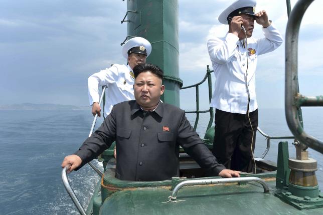 North Korean leader Kim Jong Un stands on the conning tower of a submarine during his inspection of the Korean People's Army Naval Unit 167 in this undated photo released June 16, 2014. REUTERS/KCNA