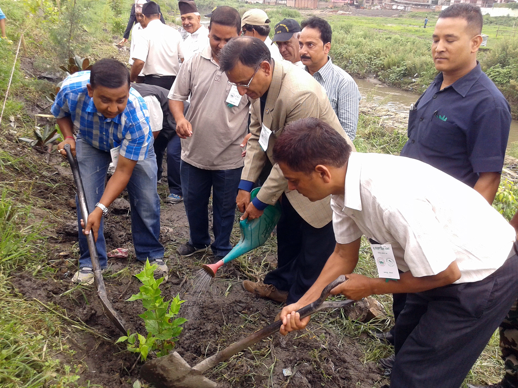 Minister for Forest and Soil Conservation Mahesh Acharya planting a plant during a programme jointly organised by the Department of Soil Conservation and Watershed Management (DoSCWM) and the Manoram Society at the bank of Manohara River in Bhaktapur on Sunday, August 09, 2015. Photo: RSSn