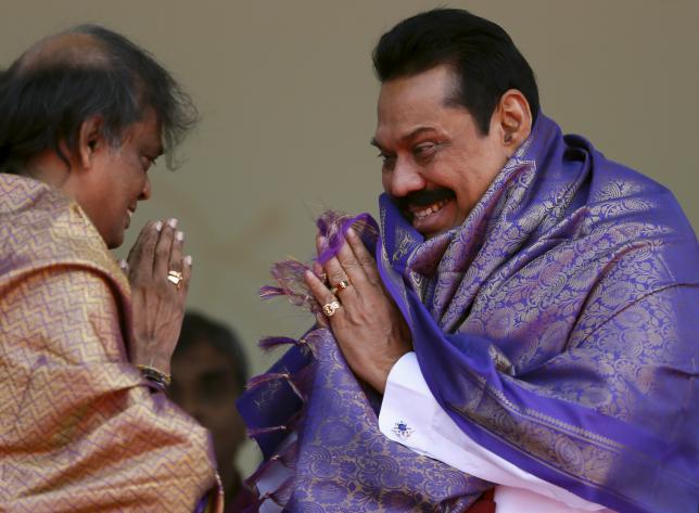 Sri Lanka's former president Mahinda Rajapaksa, who is contesting in the upcoming general election, is blessed by a Hindu priest during the launch ceremony of his manifesto, in Colombo July 28, 2015. REUTERS/Dinuka Liyanawatte