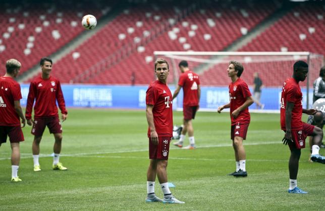 Bayern Munich's Mario Goetze (C) looks at a ball next to teammates during a training session ahead of a friendly soccer match against Valencia, at the National Stadium, also known as the Birds' Nest, in Beijing, China, July 17, 2015. REUTERS/Stringer