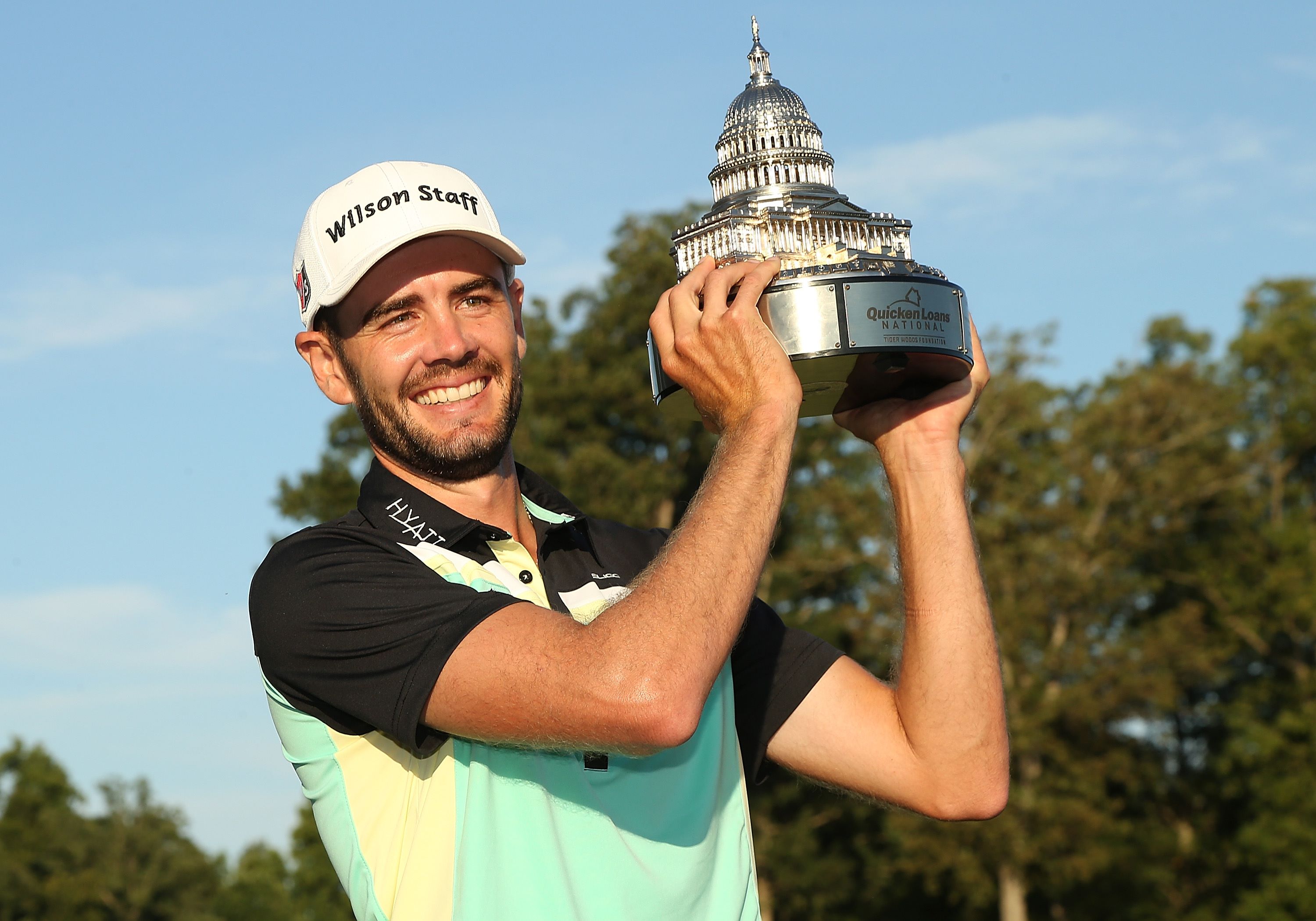 Troy Merritt celebrates with his championship trophy after winning the Quicken Loans National at the Robert Trent Jones Golf Club in Gainesville, Virginia on Sunday. Photo: AFP