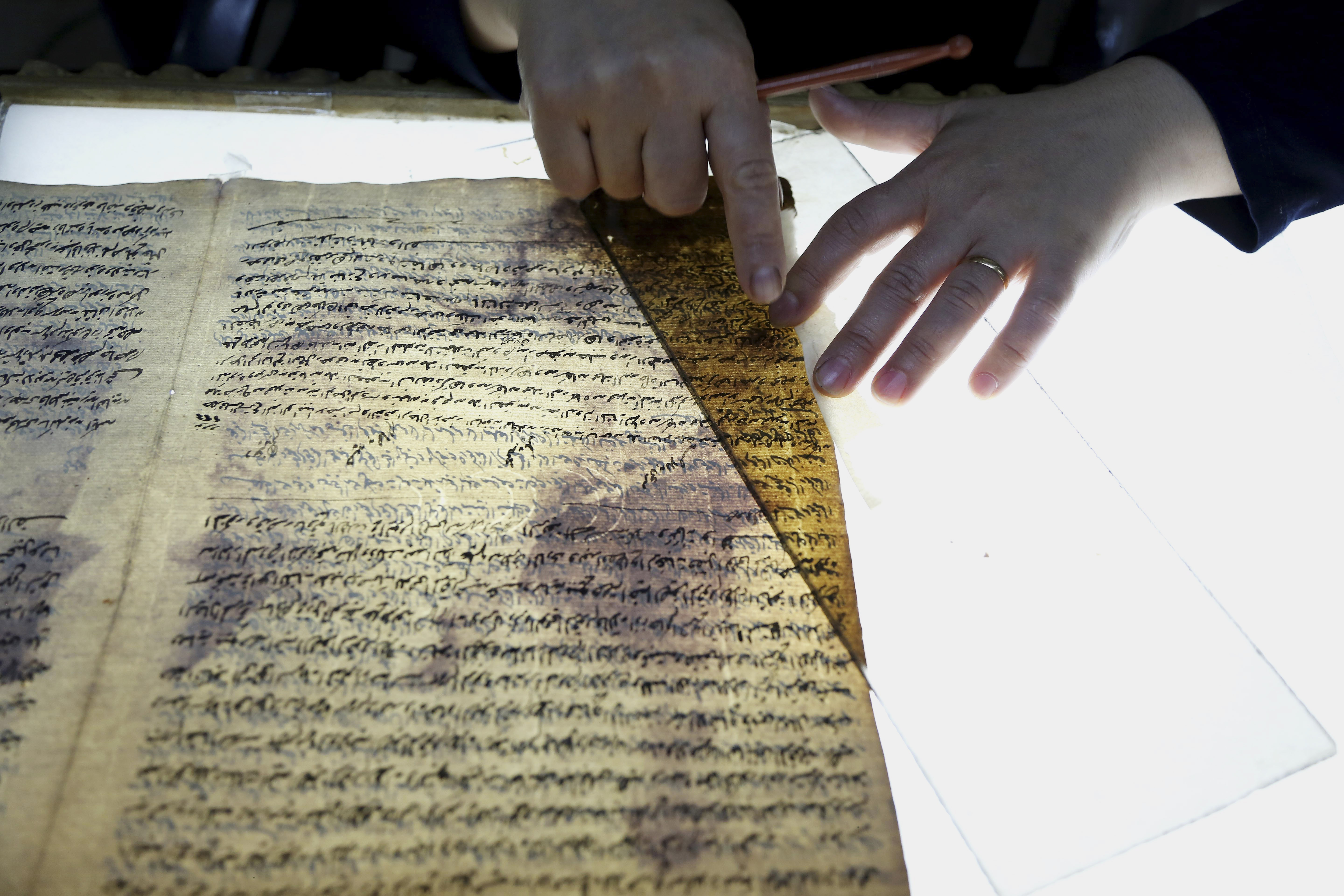In this Tuesday, July 28, 2015 photo, a member of the library restoration staff works on a damaged document at the Baghdad National Library in Iraq. As the Islamic State militants now set out to destroy Iraq's history and culture, including irreplaceable books and manuscripts kept in the militant-held city of Mosul, a major preservation and digitization project is underway in the capital to safeguard a millennia worth of history.Photo: AP 