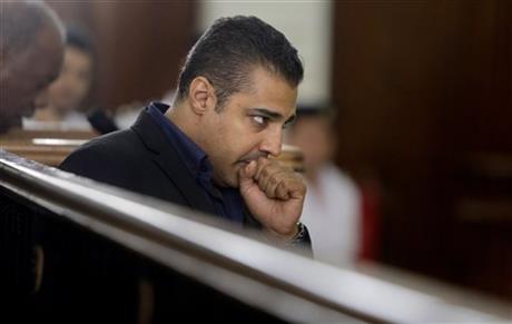 FILE - In this Thursday, June 25, 2015, file photo, Canadian Al-Jazeera English journalist Mohammed Fahmy, listens during his retrial in a courtroom, in Tora prison, in Cairo, Egypt.  AP