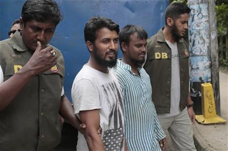 Suspected Muslim militants Kausar Hossain Khan, 29, second from right, and Kamal Hossain Sardar, 29, second from left, who were arrested in the killing of a secular blogger, are escorted to appear before the media in Dhaka, Bangladesh, Friday, Aug. 28, 2015. AP