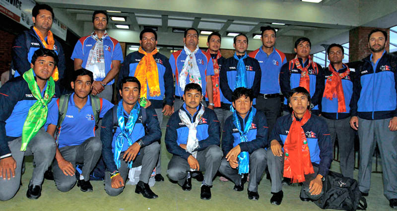 Nepal national cricket team members, along with coach Pubudu Dassanayake, pose for a photograph at TIA after returning from ICC World T20 Qualifiers held in Scotland and Ireland, on Monday. Photo: THT