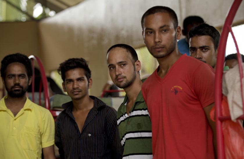 A group of migrants from Nepal stand inside a shelter during a visit by President Juan Carlos Varela, in Meteti, Panama, Monday, Aug. 17, 2015. President Varela announced Monday the construction of a shelter for migrants that enter on foot from Colombia to Panama. (AP Photo/Arnulfo Franco)