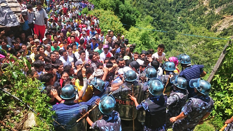 Protesters confronting the security cordon during their protest at the gate of District Development Committee, in Khalanga, nJajarkot, on Thursday. They have been protesting against merger of the district with the far-west. Photo:THT