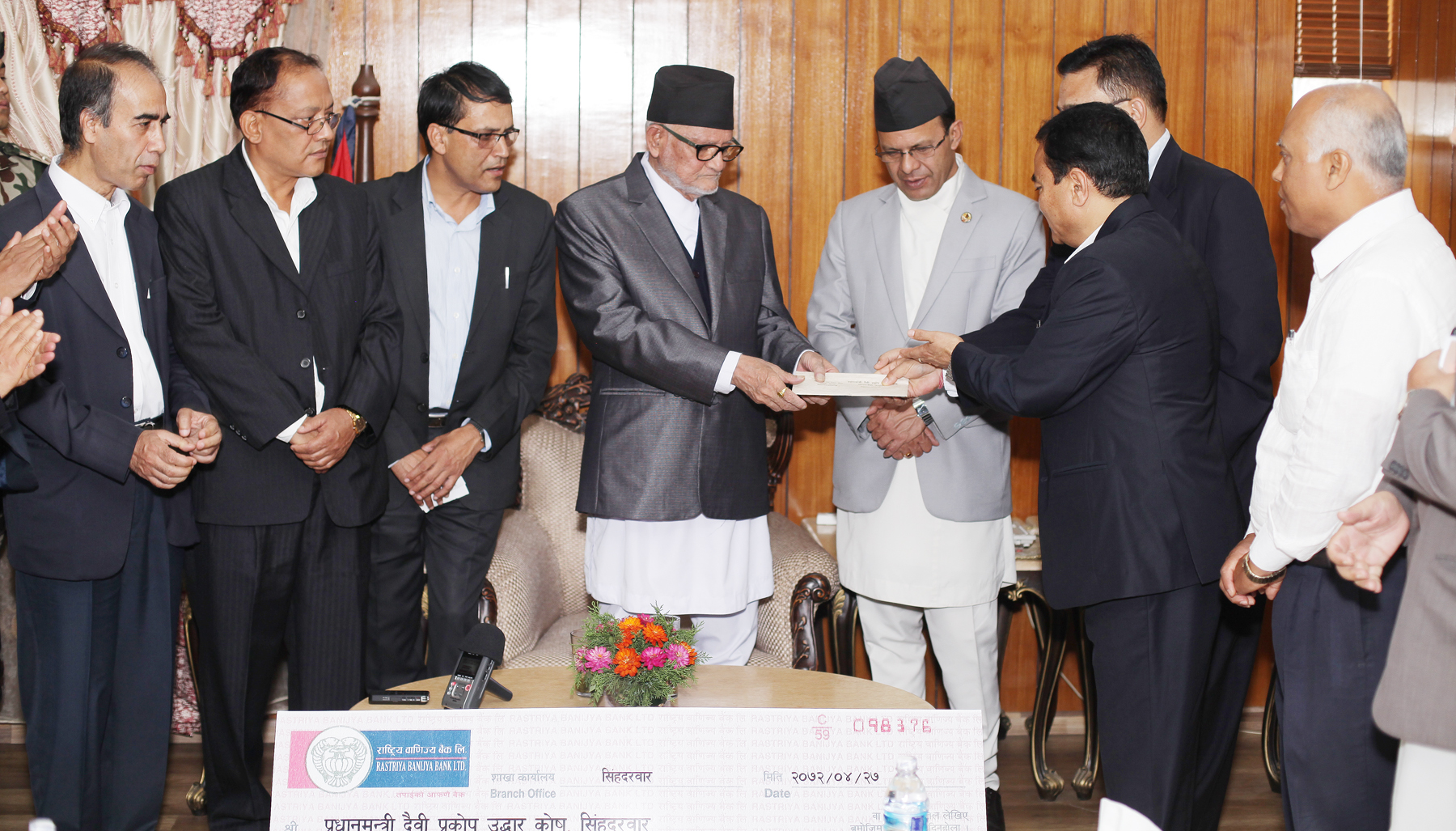 Radio Nepal Employees with the Minister for Information and Communication Dr Minendra Rijal submits relief fund worth Seventeen Lakh One Thousand Eight Hundred Sixty Four Rupees and Three Paisa to the Prime Minister Sushil Koirala for the Prime Minister's Disaster Relief Fund on Wednesday at PM's Official Residence, Baluwatar, Kathmandu. Photo: Kumar Shrestha, RSS