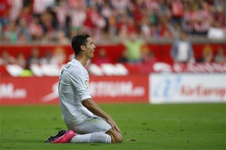 Real Madrid's Cristiano Ronaldo reacts during a Spanish La Liga soccer match between Real Madrid and Sporting de Gijon at the 'El Molinon' stadium in Gijon, Spain, Sunday, Aug. 23, 2015. AP