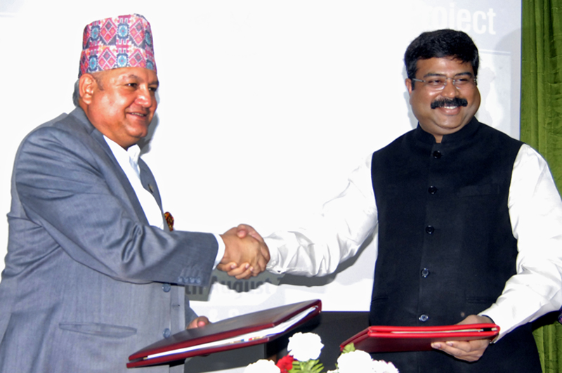 Sunil Bahadur Thapa, Minister for Commerce and Supplies, and Dharmendra Pradhan, Indian Minister of State for Petroleum and Natural Gas, exchanging files after signing the MoU on Raxaul-Amlekhganj petroleum pipeline, in Kathmandu, on Monday. Photo: THT