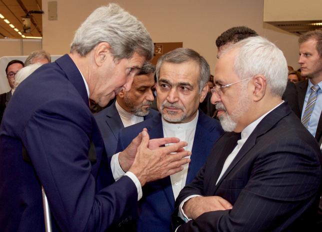 U.S. Secretary of State John Kerry (L) speaks with Hossein Fereydoun (C), the brother of Iranian President Hassan Rouhani, and Iranian Foreign Minister Javad Zarif (R), before the Secretary and Foreign Minister addressed an international press corps gathered at the Austria Center in Vienna, Austria, July 14, 2015. REUTERS/US State Department/Handout via Reuters
