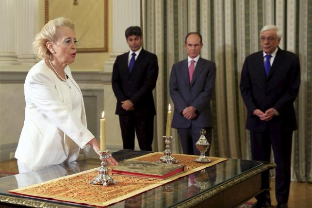 Greece's Supreme top Court judge Vassiliki Thanou (L) stands in front of President Prokopis Pavlopoulos (R) during her swearing in ceremony as the country's caretaker Prime Minister, at the Presidential Palace in Athens, Greece August 27, 2015. REUTERS/Alkis Konstantinidis