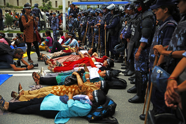 Women activists lying on road as part of their protest to demand equal rights for women in the new constitution, in New Baneshwor, Kathmandu, on Friday, August 7, 2015. Photo:THT