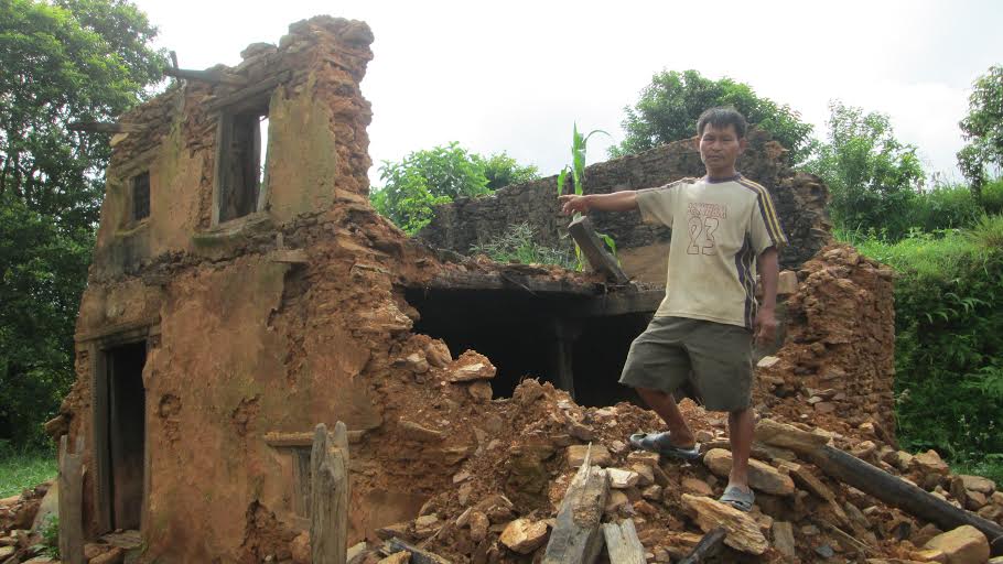 Shankar Singh Thakuri (46) showing his collapsed house in Raniswanra, Manpang-6 of Tanahun district on Saturday, August 08, 2015. Photo: Madan Wagle