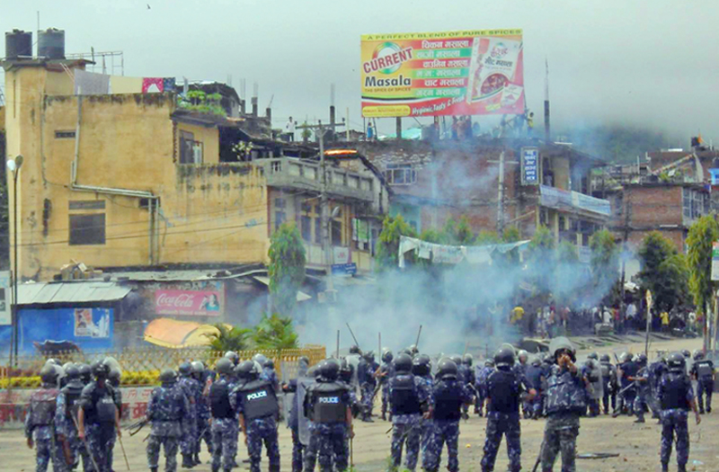 Police chasing demonstrators after locals staged a demonstration demanding that the mid-west be kept intact, at Birendranagar, Surkhet, on Tuesday. Photo: THT
