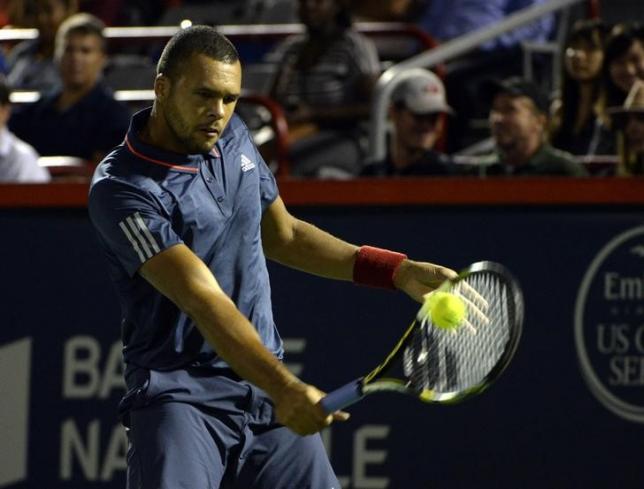 Aug 10, 2015; Montreal, Quebec, Canada; Jo-Wilfried Tsonga of France hits the ball against Borna Coric of Croatia (not pictured) during the Rogers Cup tennis tournament at Uniprix Stadium. Mandatory Credit: Eric Bolte-USA TODAY Sports