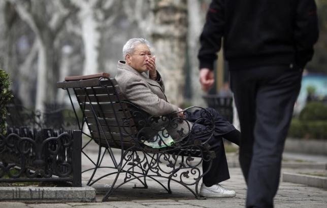 An elderly man sits at a park in Shanghai March 16, 2012.  REUTERS/Carlos Barria