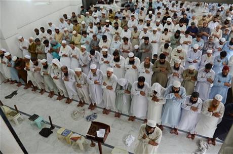 People offer funeral prayers for Taliban leader Mullah Mohammad Omar at a mosque in Peshawar, Pakistan, Friday, July 31, 2015.  AP
