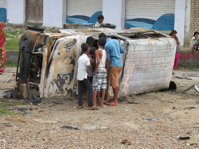 Local children look at the ambulance that was set ablaze on Monday evening by the protesters in Gaur of  Rautahat district, on Tuesday, August 25, 2015. Photo: Prabhat Kumar Jha