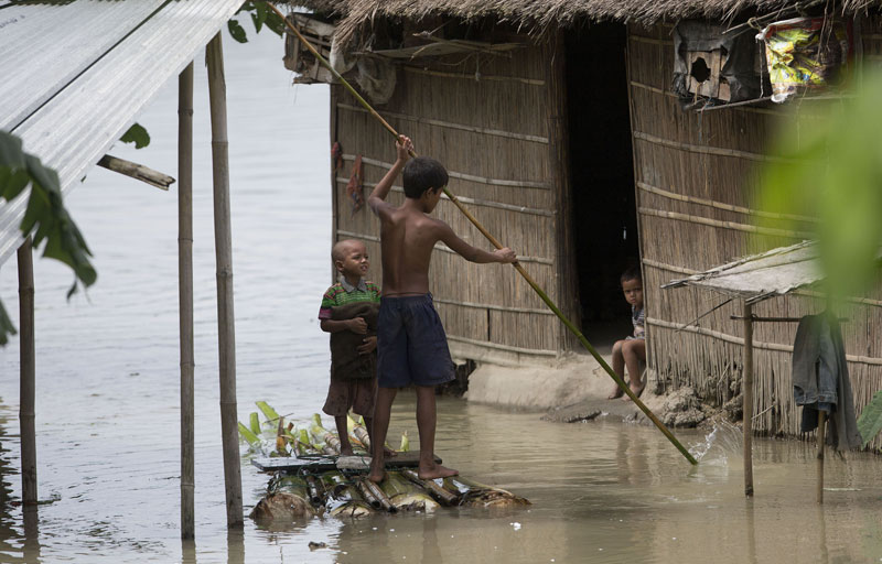 Indian children paddle a makeshift banana raft through a flood affected area in Burhaburh village, about 60 kilometers (37 miles) east of Gauhati, India , Saturday, Aug. 22, 2015. Photo: AP 