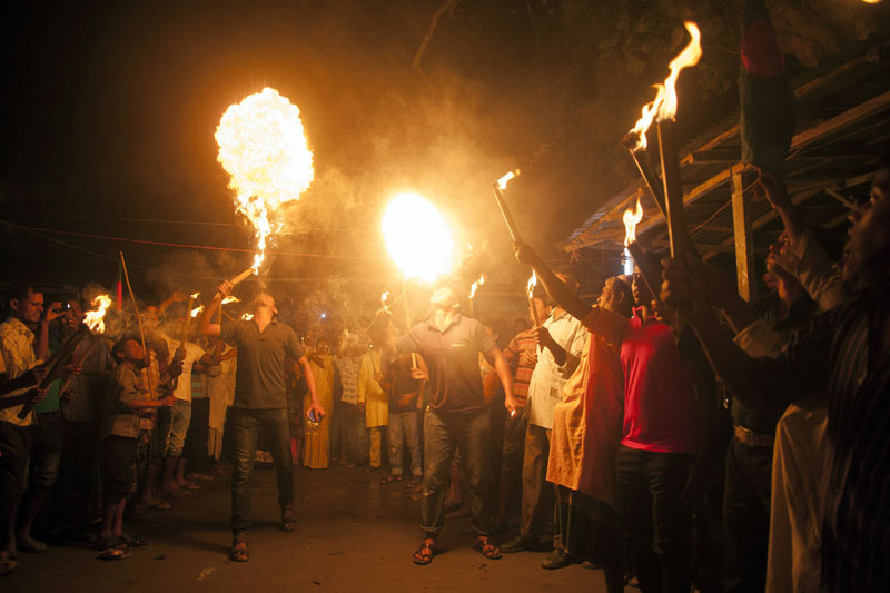Jubilant crowds celebrating  with fire eating tricks as Bangladesh and India swap tiny islands of land, ending one of the world's most intractable border disputes in Dasiarchhara, Kurigram, Bangladesh, on Saturday. Photo: AFP