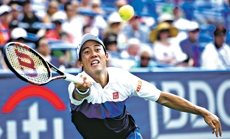 Kei Nishikori of Japan, reaches for the ball against John Isner during their men's singles final at the Citi Open tennis tournament, on Sunday. Photo: AP