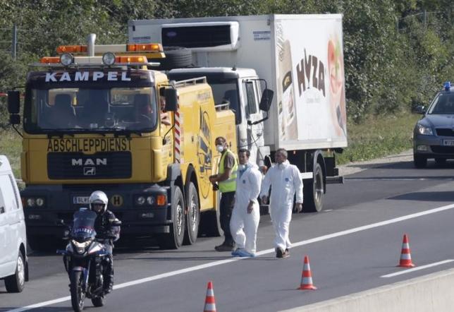 A truck in which up to 50 migrants were found dead, is prepared to be towed away on a motorway near Parndorf, Austria August 27, 2015.  REUTERS/Heinz-Peter Bader