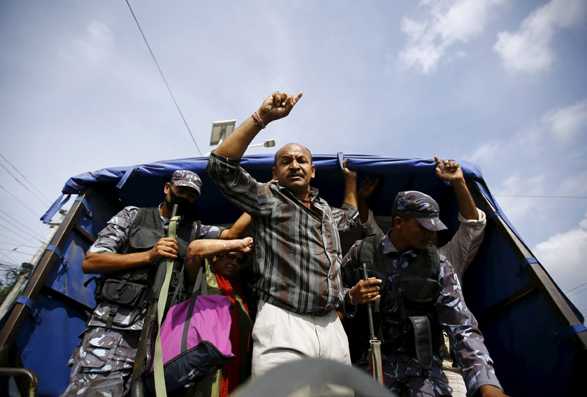 A protester chants slogans from a police vehicle while detained by Nepalese police during a general strike organised by a 30-party alliance led by a hardline faction of former Maoist rebels, who are protesting against the draft of the new constitution, in Kathmandu, Nepal August 16, 2015.  Photo: Reuters