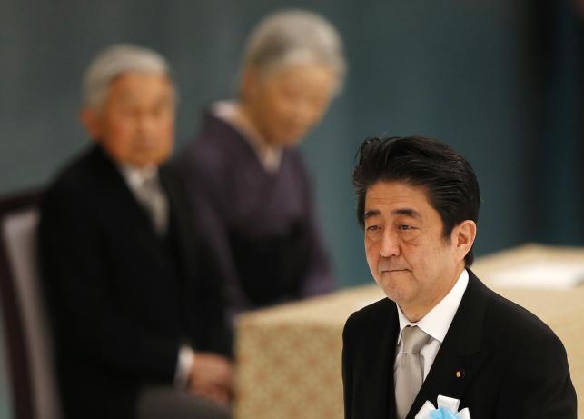 Japan's Prime Minister Shinzo Abe (R) walks past Japan's Emperor Akihito (L) and Empress Michiko during a memorial service ceremony marking the 70th anniversary of Japan's surrender in World War Two at Budokan Hall in Tokyo August 15, 2015. Photo:Reuters