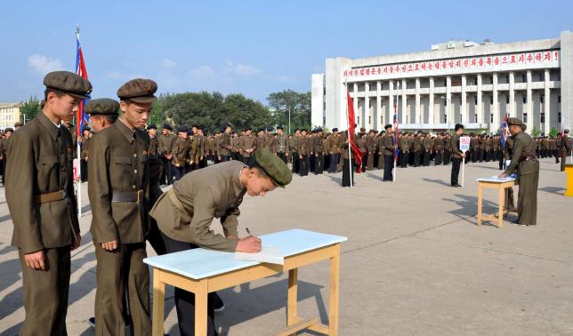 North Koreans sign up to join the army in the midst of political tension with South Korea, in this undated photo released by North Korea's Korean Central News Agency (KCNA) in Pyongyang August 23, 2015. REUTERS/KCNA