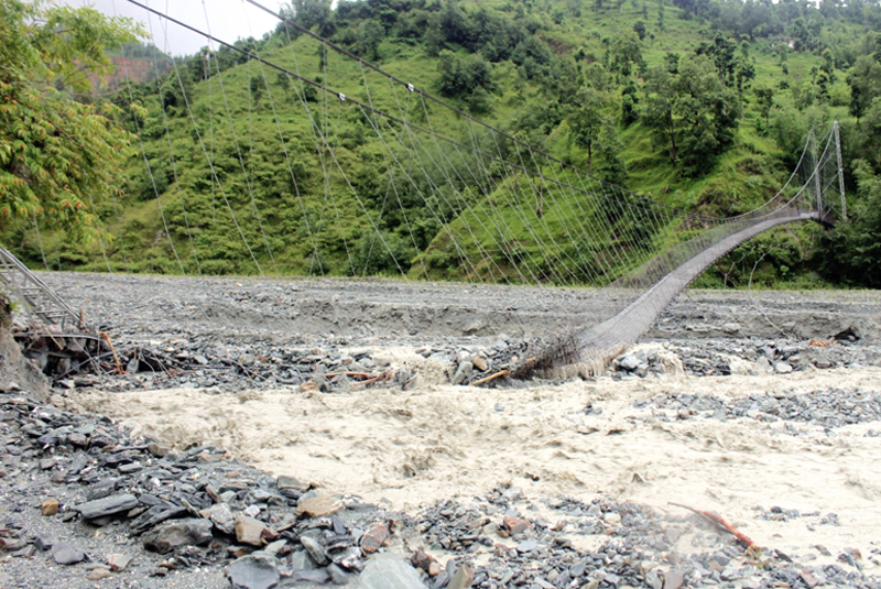 A suspension bridge over Korte Khola, which collapsed due to flood caused by incessant rainfall, in Okhaldhunga, on Monday. Photo: THT