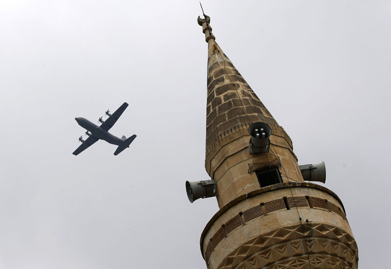 With a mosque's minaret in the foreground, a United States Air Force cargo plane takes off from the Incirlik Air Base, in the outskirts of the city of Adana, southern Turkey, Thursday, July 30, 2015. Photo: AP 