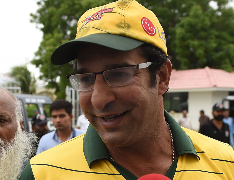 Pakistanu2019s former cricket captain Wasim Akram talks to media as he arrives at the National Cricket Stadium in Karachi on Wednesday. Photo: AFP