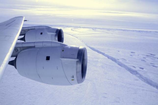 NASA's DC-8 flies across a crack, 18 miles (29 km) in length, forming across the Pine Island Glacier ice shelf in this October 26, 2011 handout photograph. REUTERS/NASA/GSFC/Jefferson Beck/Handout