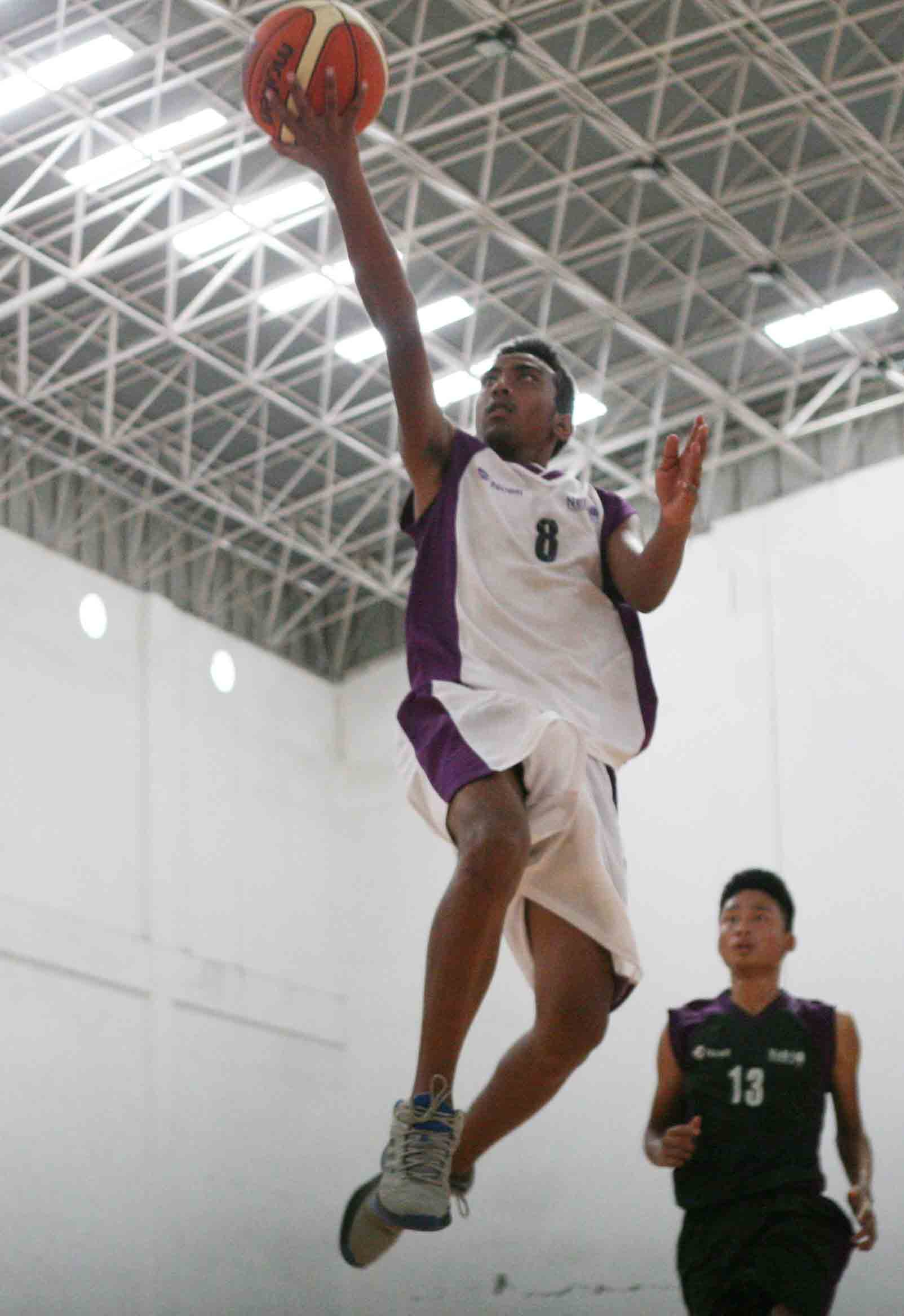 Jasang Sunwar of Golden Gate College jumps in the air for a two pointer against Xavier International College during the Ncell U-18 Inter College Basketball Championship at Nepali Army Sports Complex in Lalitpur on Wednesday. (Photo: Udipt Singh Chhetry)