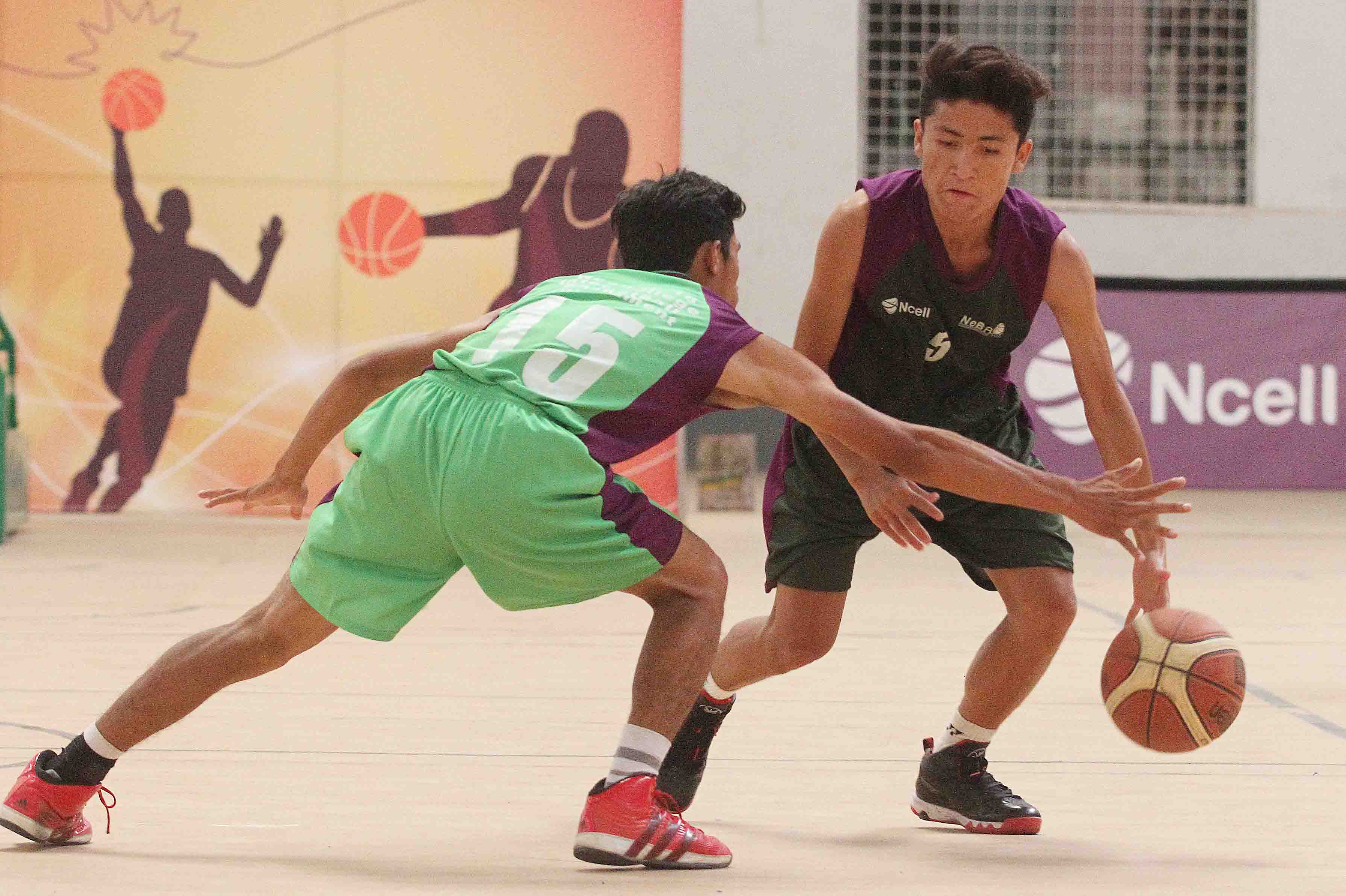 Tsewang G. Bista (right) of Xavier International College drives the ball against Suraj Lama of NASA International College during the Ncell U-18 Inter College Basketball Championship at Nepali Army Sports Complex in Lalitpur on Friday. (Credit Image: Udipt Singh Chhetry)