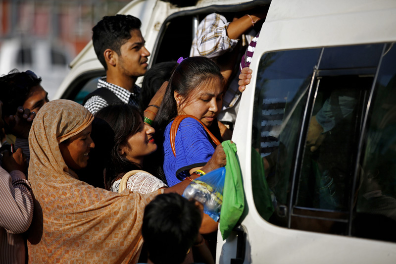 Passengers have a difficult time getting inside a public vehicle as fuel crisis deepened as imports from India were obstructed due to blockade in Old Bus Park, Kathmandu on Tuesday. PHOTO/SKANDA GAUTAM