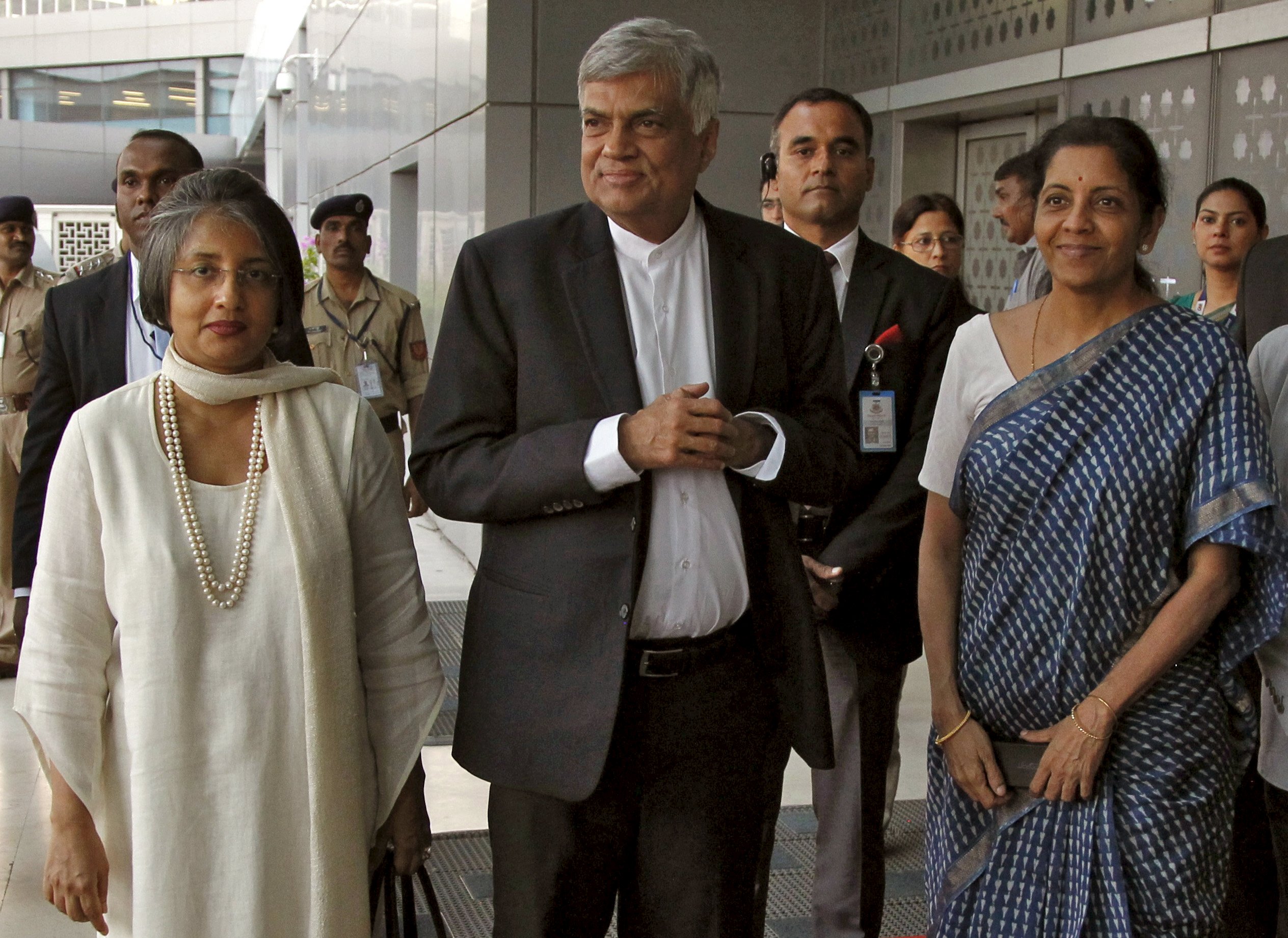 Sri Lanka's Prime Minister Ranil Wickremesinghe (C), his wife Maitree (L) and India's Commerce and Industry Minister Nirmala Sitharaman pose for photographs after Wickremesinghe arrived at the Indira Gandhi international airport in New Delhi, India, September 14, 2015. Wickremesinghe is on a three-day official visit to India. REUTERS/Stringer