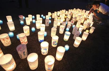 A man lights candles during a candle light installation event in Naraha, Fukushima, northern Japan, Friday, Sept. 4, 2015. Residents of Naraha will returns from Saturday to live in the town near the Fukushima nuclear power plant for the first time since the 2011 disaster. Photo: AP