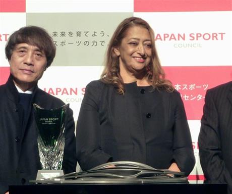 In this March 19, 2013 photo, architect Zaha Hadid, right, smiles with a trophy and a scale model of her design after winning the international competition for Japan's national stadium that hosts the Tokyo 2020 Olympic Games, accompanied by the competition jury chair Tadao Ando, during an awarding ceremony in Tokyo. Zaha Hadid Architects, the company whose stadium design for the Tokyo 2020 Olympics was chosen and later scrapped, said Monday, Sept. 7, 2015 it is teaming up with major Japanese design and engineering company Nikken Sekkei in a bid to regain the project. Prime Minister Shinzo Abe announced in July that the design by star Iraqi-British architect Hadid had been dropped as too costly, seeking to quiet an outcry over the futuristic, huge stadium blueprint. Photo: AP