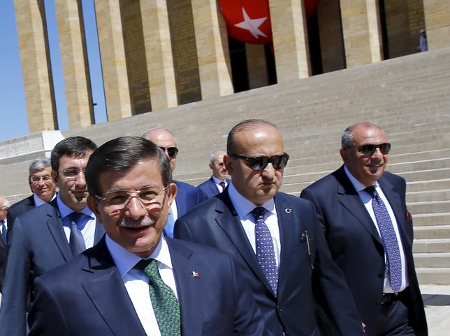 Turkey's Prime Minister Ahmet Davutoglu (L) leaves a wreath-laying ceremony at Anitkabir, the mausoleum of modern Turkey's founder Mustafa Kemal Ataturk, as he is flanked by his ministers in Ankara, Turkey, September 1, 2015. REUTERS/Umit Bektas