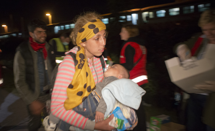 Migrants walk towards Hungary after arriving by train in Botovo, Croatia, on the Hungarian border, Tuesday, Sept. 22, 2015. At a contentious meeting, European Union ministers agreed Tuesday to relocate 120,000 refugees among the bloc to ease the strains on front-line nations like Greece and Italy, which are being overwhelmed by the continent's ballooning migrant crisis. Photo: AP