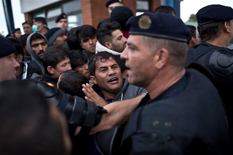 A man reacts as he gets pushed back by Croatian police officers in Opatovac, Croatia on Tuesday, Sept. 22, 2015. Photo: AP