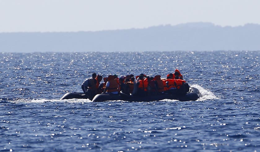 File- Migrants aboard a dinghy sail off for the Greek island of Lesbos as it travel from the southern Turkish coastal town of Behramkale in the Aegean sea between Turkey and Greece, August 27, 2015. Photo: Reuters