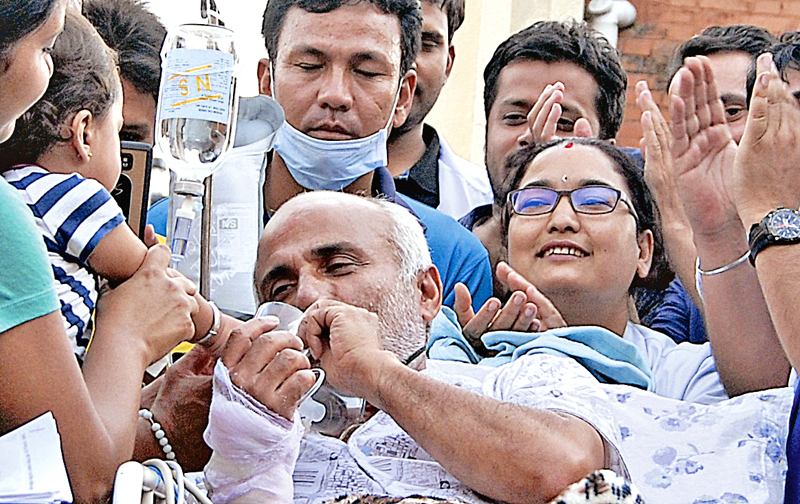 Dr Govinda KC ends his fast-unto-death, drinking from a glass of juice offered by an 18-month-old child, at Tribhuvan University Teaching Hospital, Maharajgunj, Kathmandu, on Sunday. Photo: THT