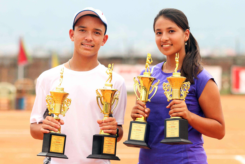 Samrakshyak Bhushan Bajracharya and Mayanka Rana hold their trophies after the seventh Kesha-JTI Junior Tennis Tournament in Lalitpur on Saturday. Photo: Udipt Singh Chhetry/THT