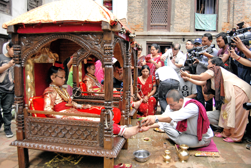 Living gods, the reincarnations of Lord Ganesha (left) and Lord Bhairava (right), being worshipped by a priest as part of Indra Jatra, in  Kathmandu, on Thursday. Photo: Bal Krishna Thapa / THT